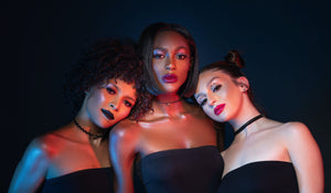 three LipRevolt models wearing the following LipRevolt shades: Dissident, Uproar, and Heroine.